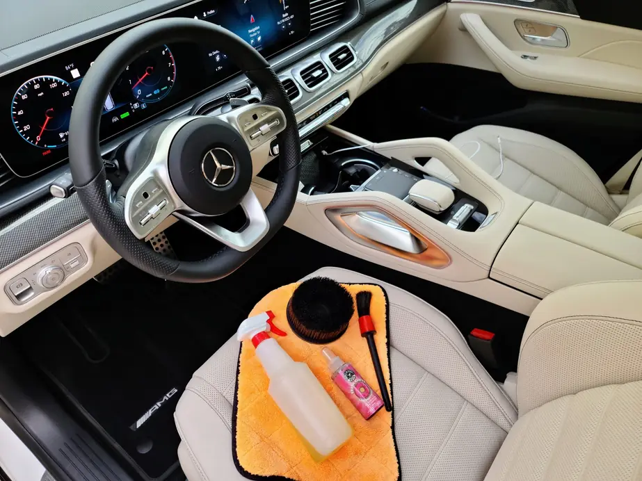 Cream leather Mercedes-AMG interior mid-detail with a cleaning kit on the seat