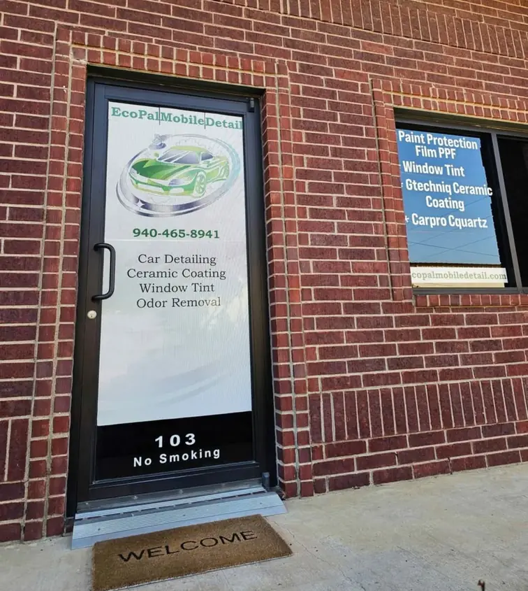 The ECOPAL Mobile Detail studio door at suite 103 with the phone number and services lettered on the glass